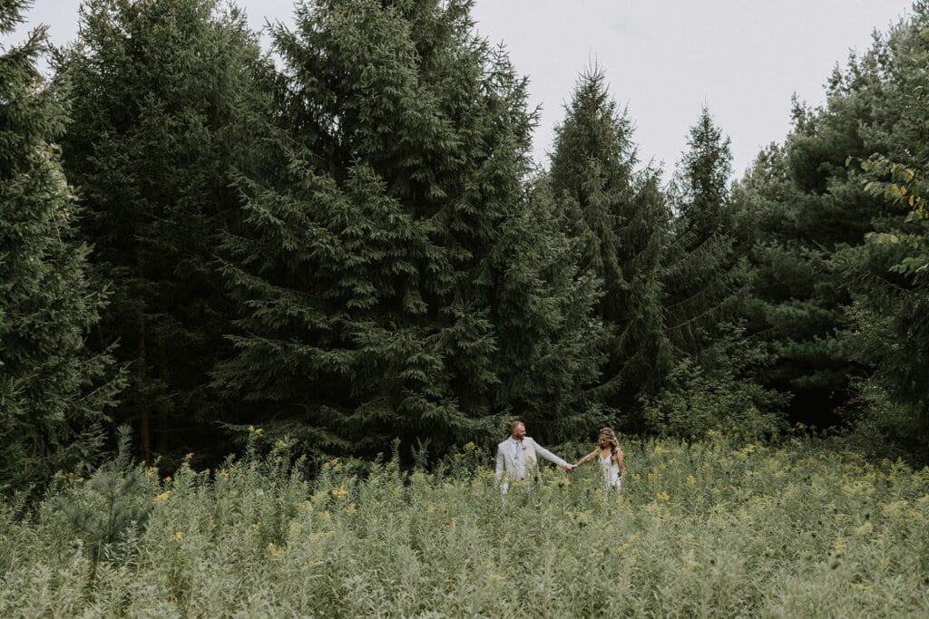 A couple strolling through our Twin Cities Sustainable Wedding Venue on their wedding day.