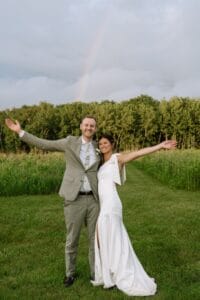 Turning your raining day blues into rainbows. You can see the newlywed couple still loved their raining day adventure in our nature-inspired wedding venue when they found a rainbow in our wildflower field. 