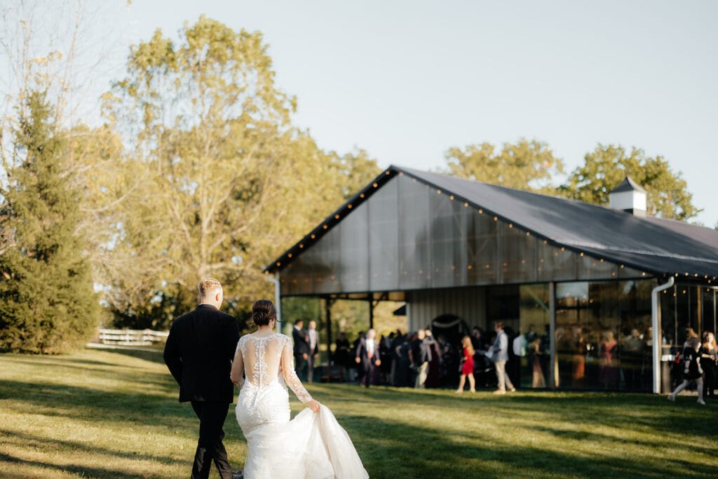 A view of a Twin Cities Sustainable Wedding Venue from the wedding couple's perspective. Our glass pavilion full of family and friends